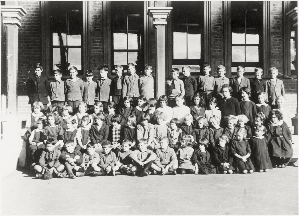 boys and girls in front of a school