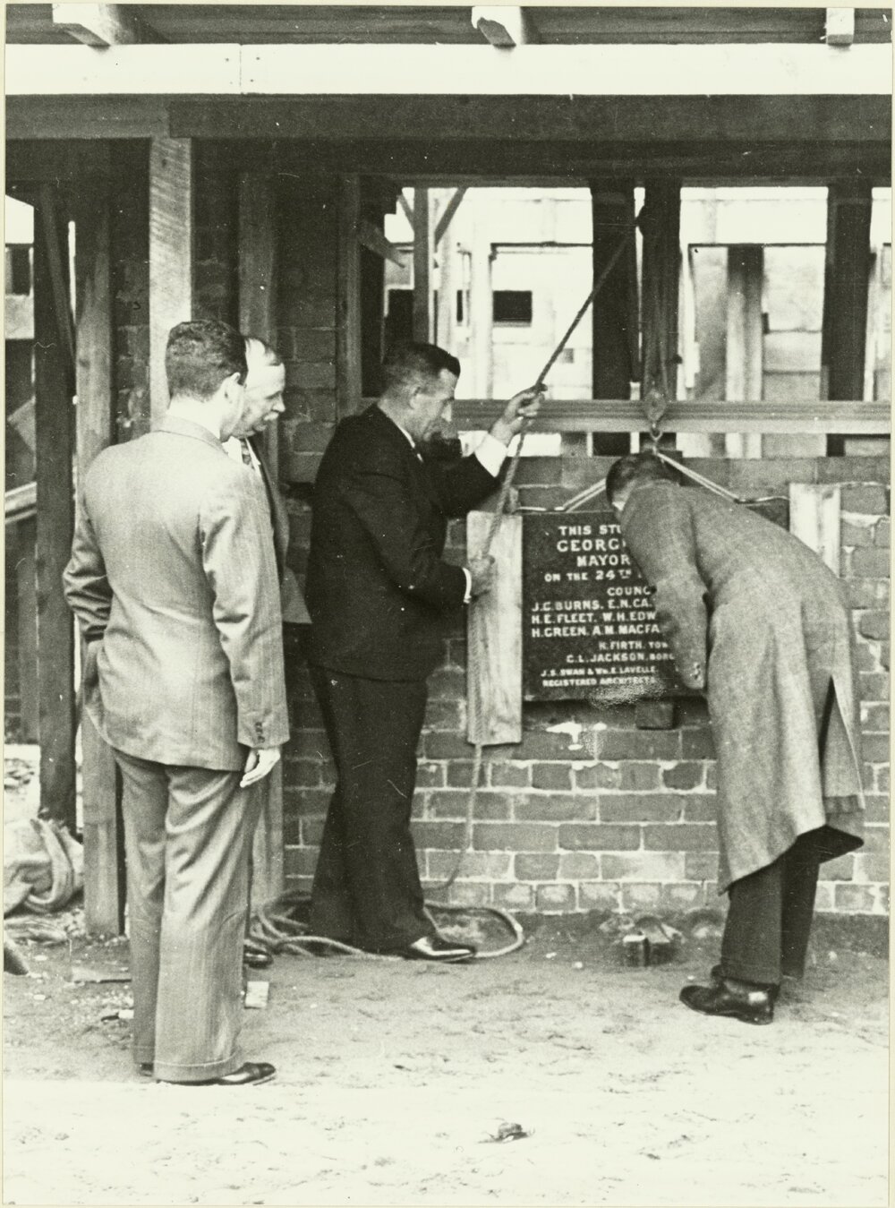 Grandstand at recreation ground: laying [the] foundation stone