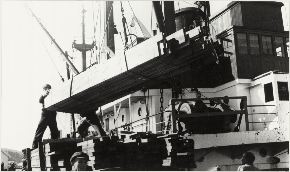 Unloading timber from West coast