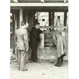 Grandstand at recreation ground: laying [the] foundation stone
