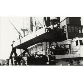 Unloading timber from West coast